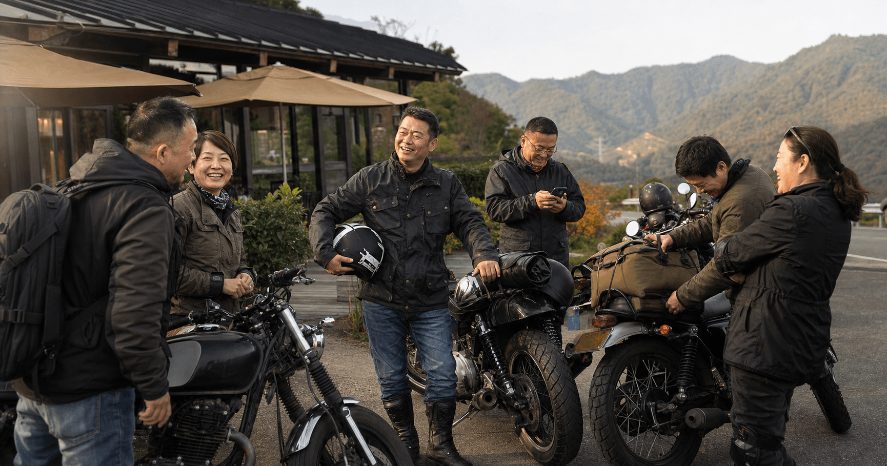 一群朋友在山间公路旁整理摩托车装备并开心交流